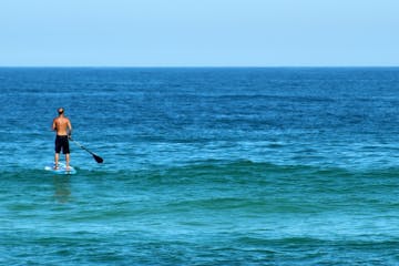 a person riding a surf board on a body of water
