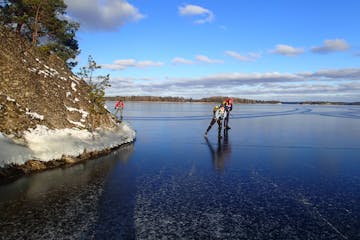 two people ice skate on natural ice
