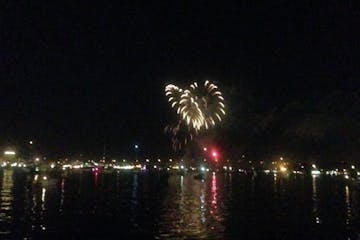 fireworks in the night sky over a body of water
