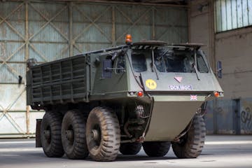 a large military truck parked on the side of a vehicle
