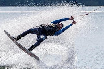 a man riding a wave on a surf board on a body of water