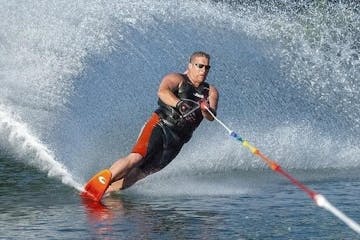 a man riding skis on a body of water
