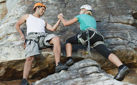 Climbers Scaling Steep Rock