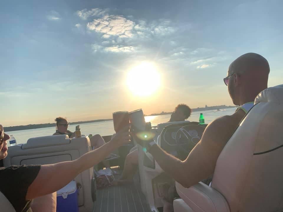lake mendota boat rental, a group of people holding wine glasses