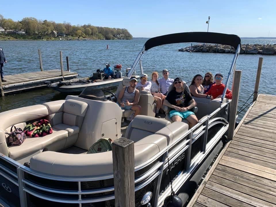 madison pontoon rental, a group of people in a boat on a body of water