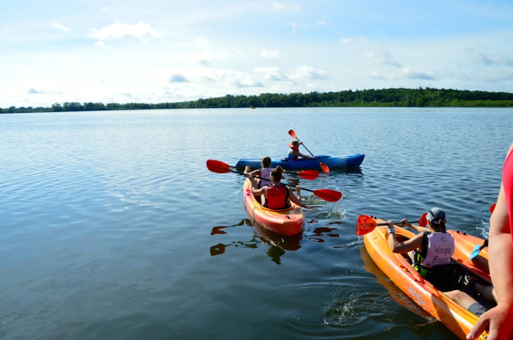 a group of people in a small boat in a body of water