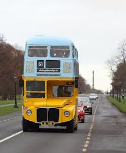 a double decker bus driving down the road