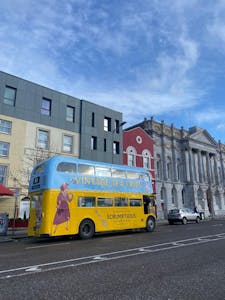 a double decker bus parked on the side of a building