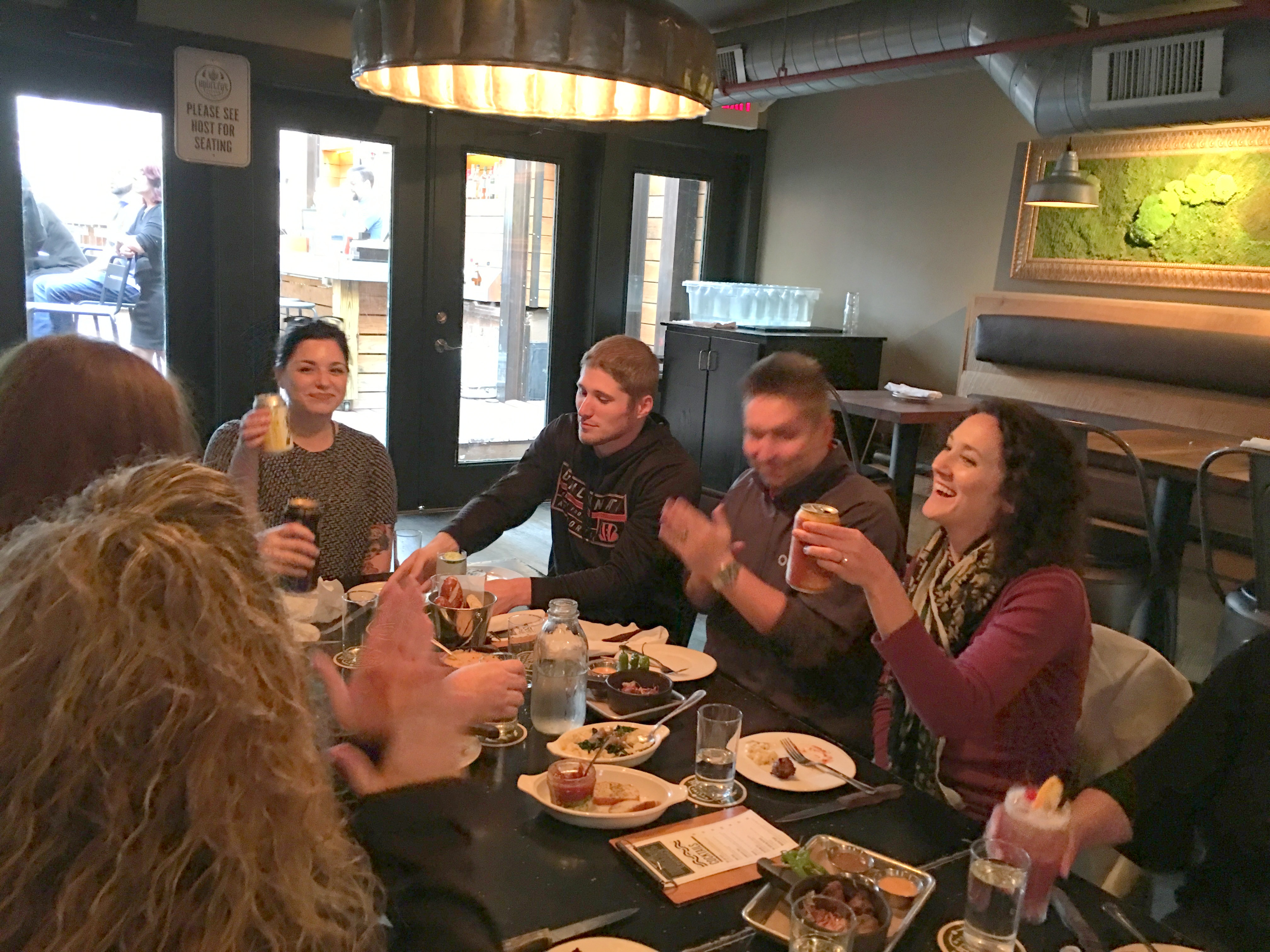 a group of people sitting at a table eating food