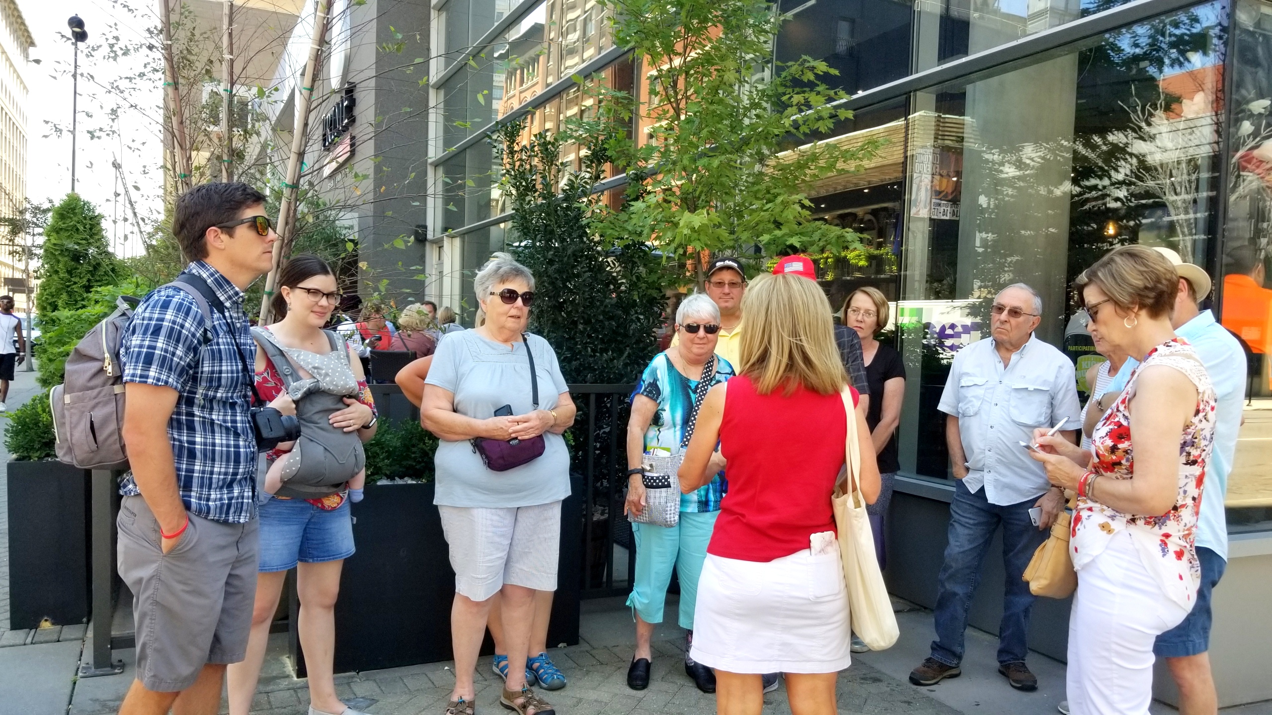 a group of people standing on a sidewalk