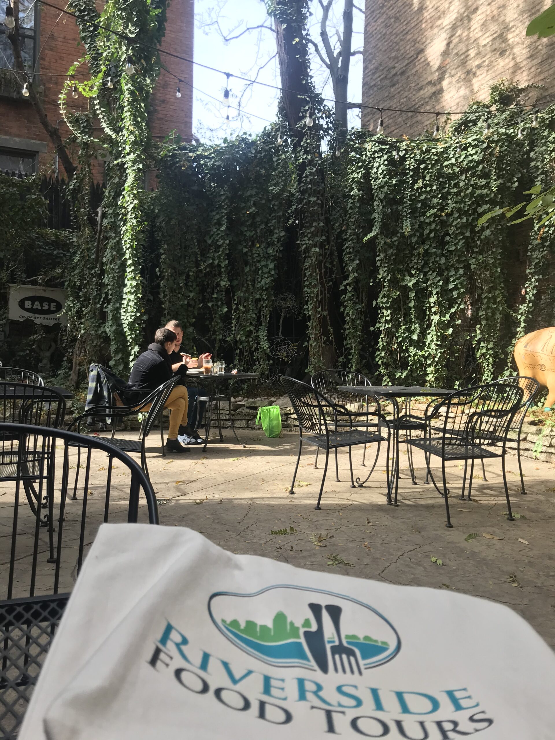 a person sitting on a bench in a park