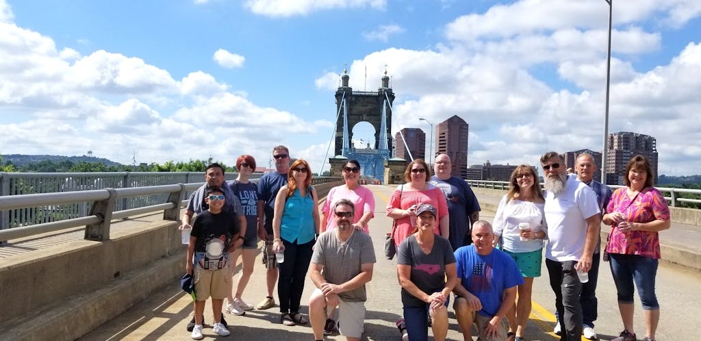 people standing in front of the Roebling Bridge