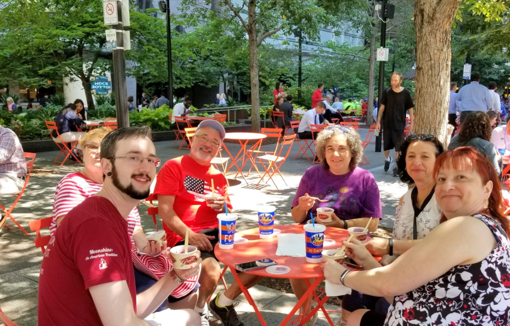 a group of people sitting at a table eating food