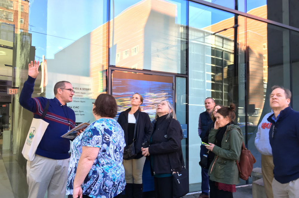 a group of people looking up at a building