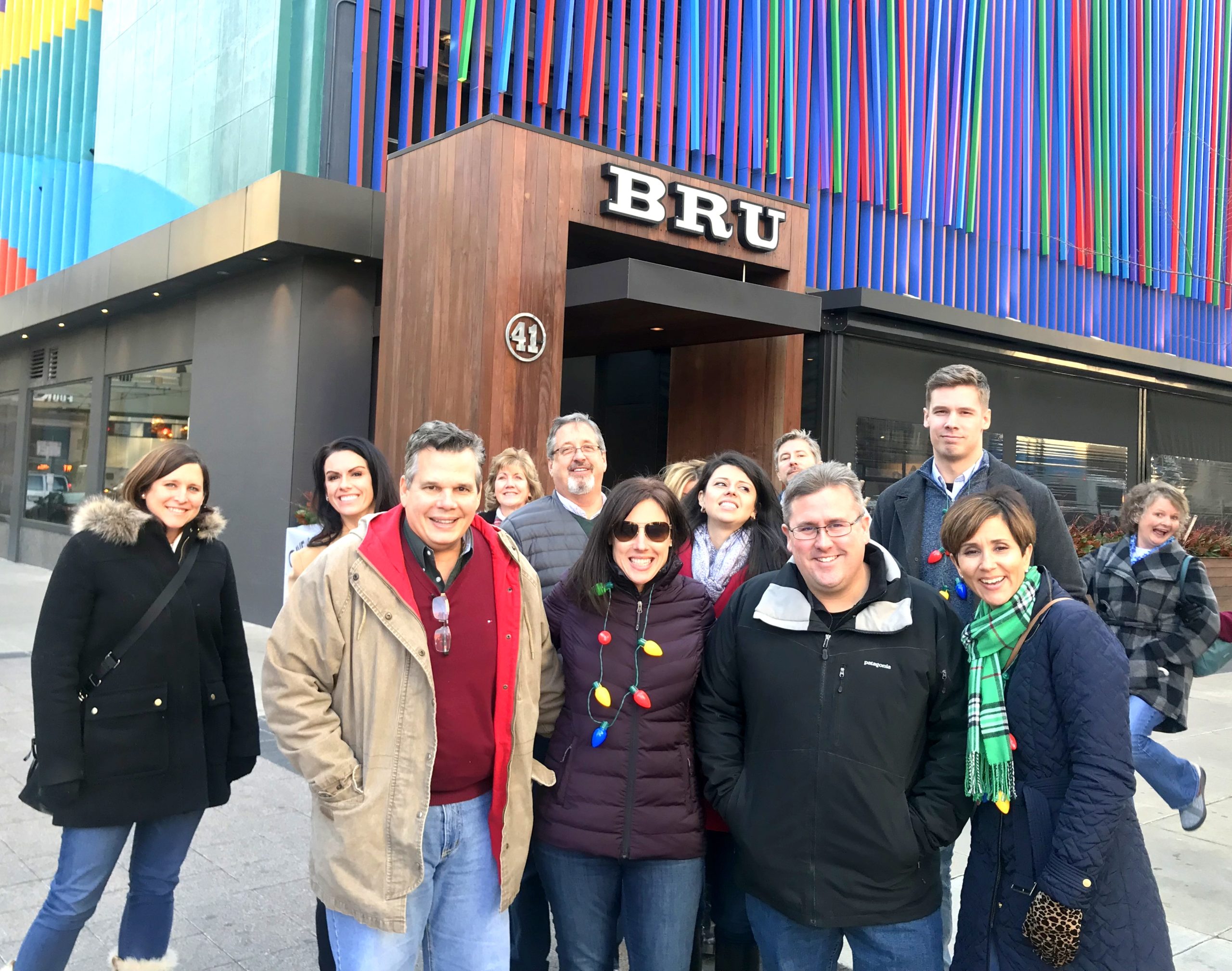 Gabriella Vidus et al. posing for a photo in front of a building