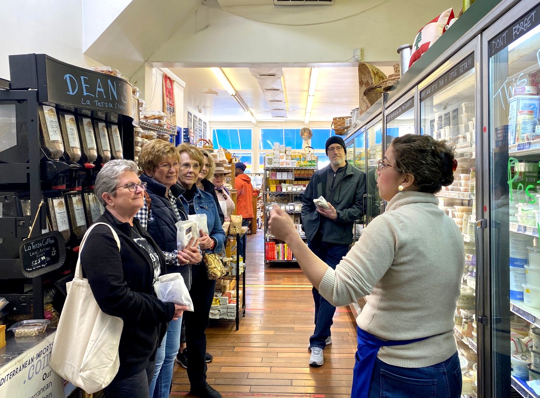 a group of people standing in front of a store