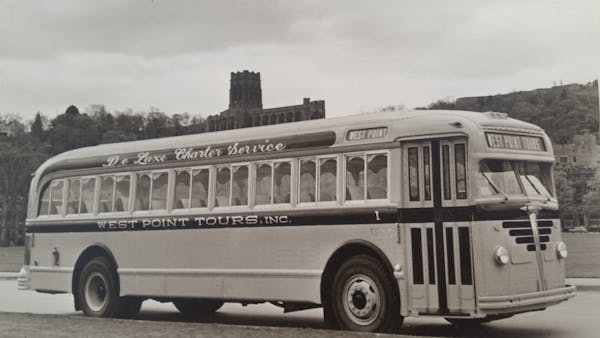 a black and white photo of a bus