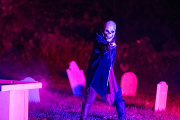 A skeleton actor in a graveyard during the Legacy of Sleepy Hollow event.
