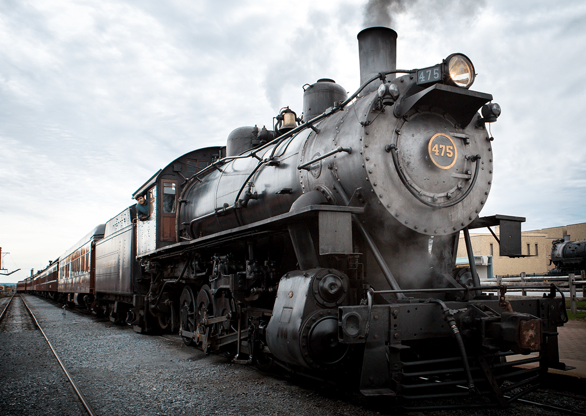 A steam locomotive sitting on a train track.