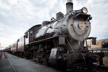 A steam locomotive sitting on a train track.