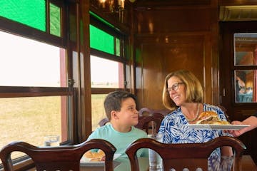 A mom and her son being served lunch on Strasburg Rail Road's dining train.