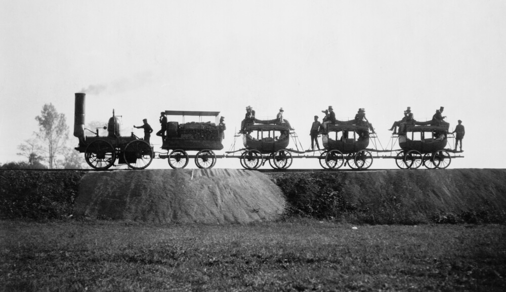 a group of people riding on the back of a 4-part carriage