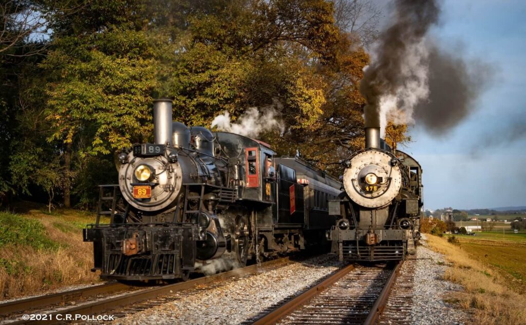 steam engines 89 and 475 on the train tracks side-by-side