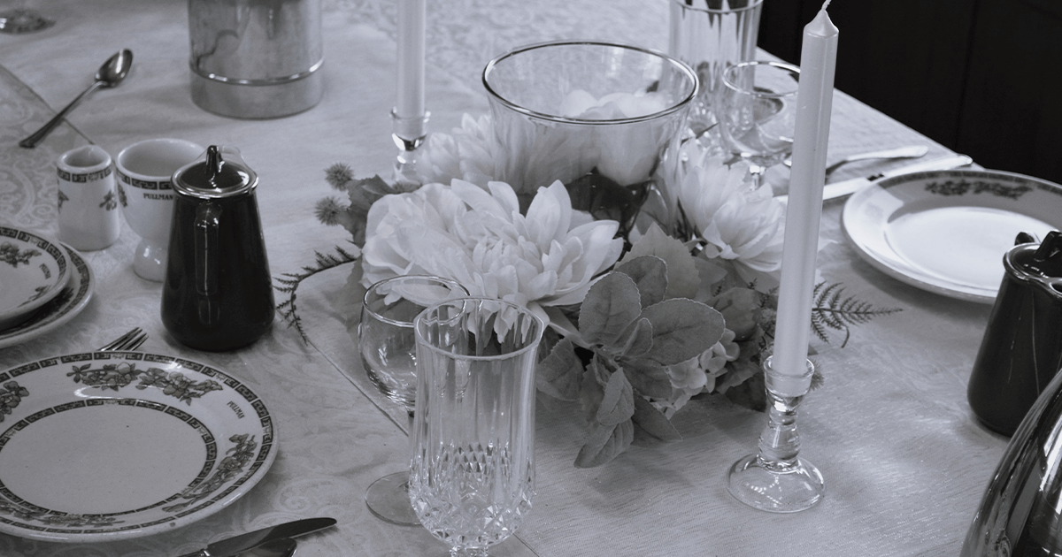 Black and white vintage image of the table setting of a Pullman dining car.