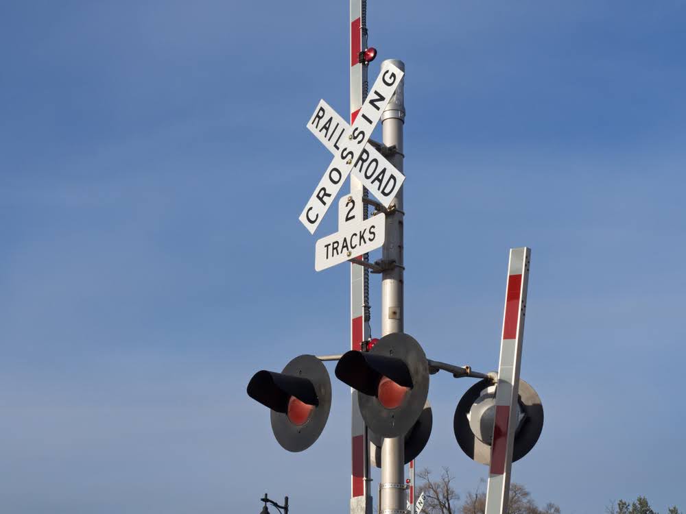 Close-up of a railroad crossing sign with lights.