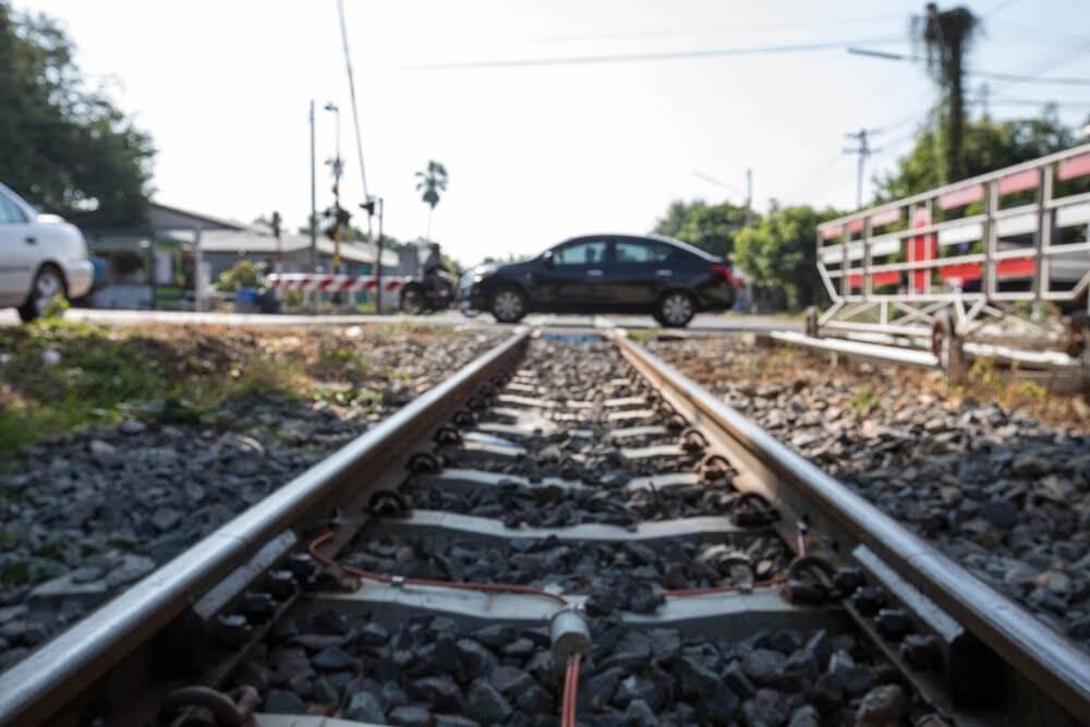 A car sitting on a steel railroad track.