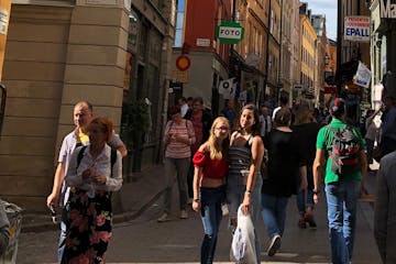 a group of people walking on a city street