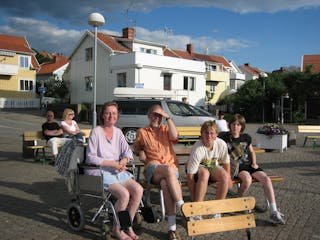 a group of people sitting in front of a building