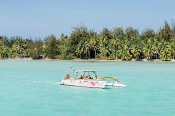 A Polynesian outrigger sailing in Bora Bora