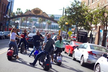a group of people riding motorcycles on a city street
