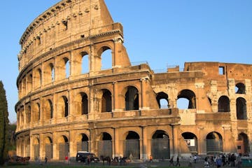 a large stone building with Colosseum in the background