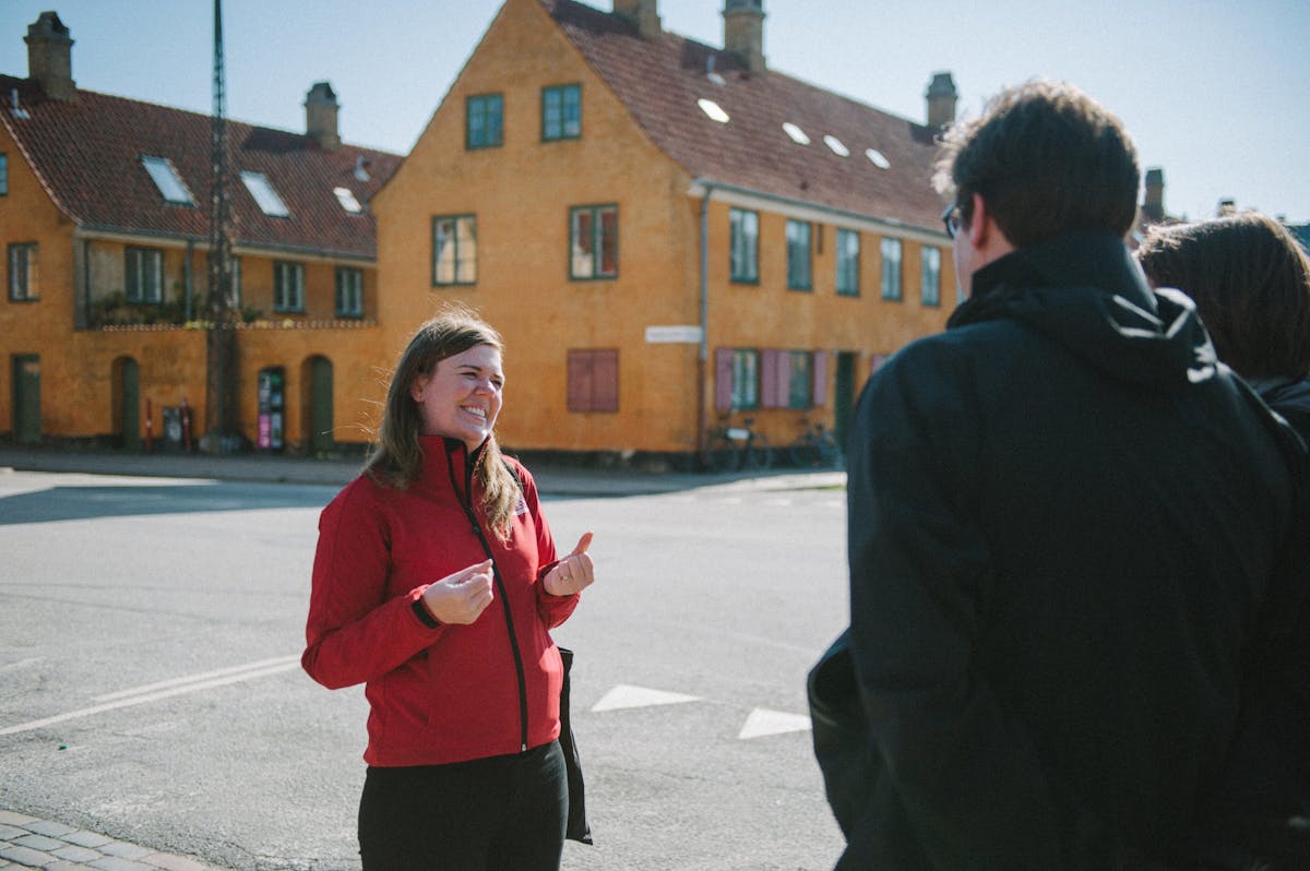 a man and a woman standing in front of a red building