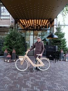 a person with a bicycle in front of a building
