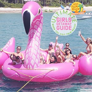 a group girls on a large floating pink flamingo