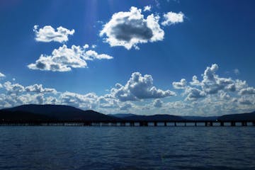 a group of clouds in the sky over a body of water