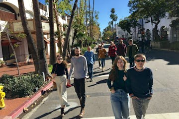 a group of people walking on a sidewalk