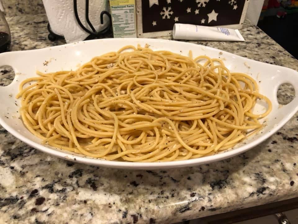 a bowl of pasta sits on a plate
