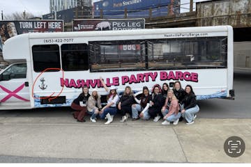 a group of people standing in front of a bus