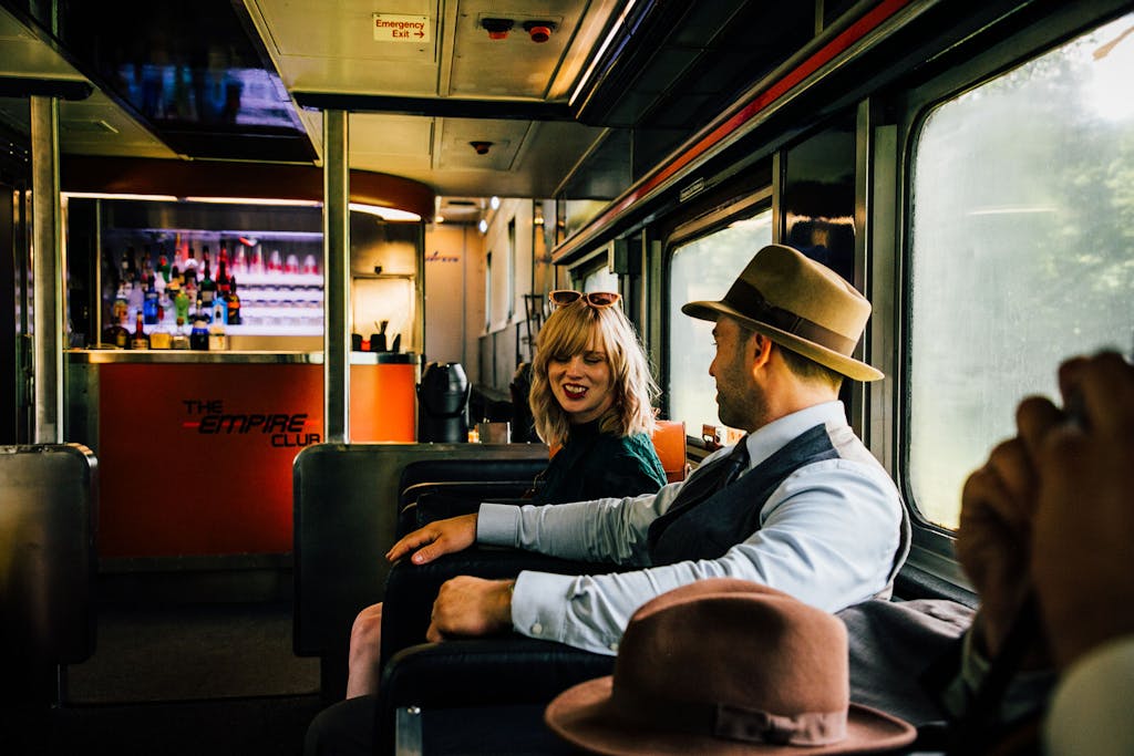 a man and a woman sitting on a bus