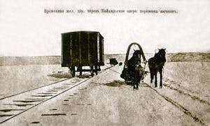 a person riding a horse drawn carriage