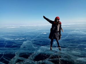 standing on transparent lake Baikal during the winter Russia tour