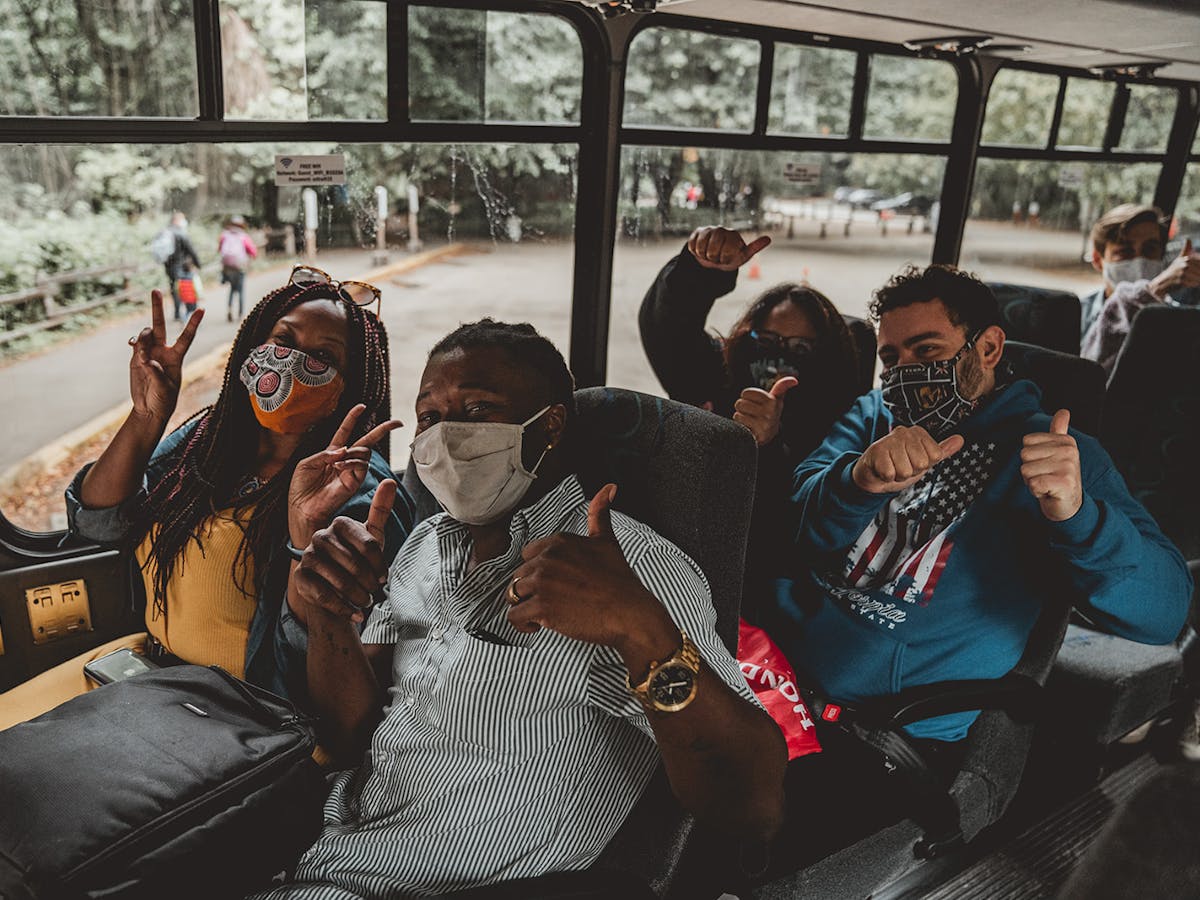 group of people on bus wearing masks
