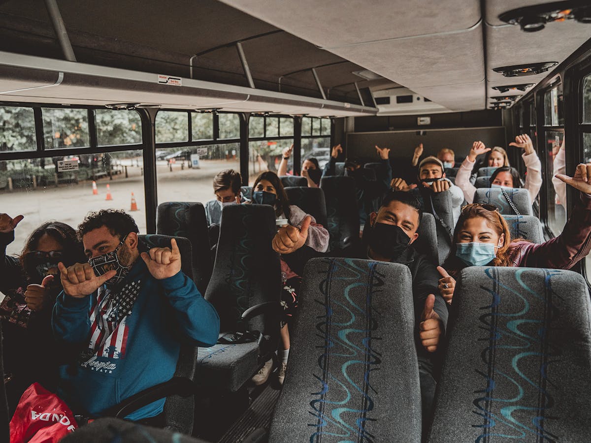 tour group on bus wearing masks
