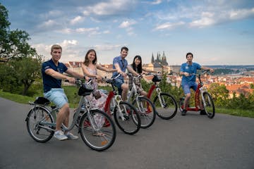 a group of people riding on the back of a bicycle