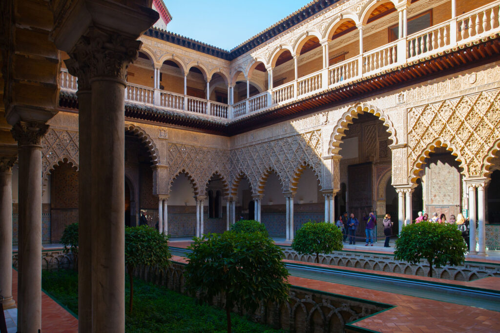 a statue in front of Alcázar of Seville