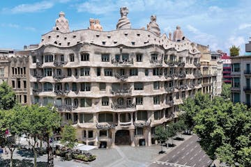 a large building with Casa Milà in the background